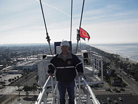 Worker on scaffolding above city
